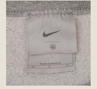 Early 2000s Nike silver tag with a tonal swoosh on a silver-gray label