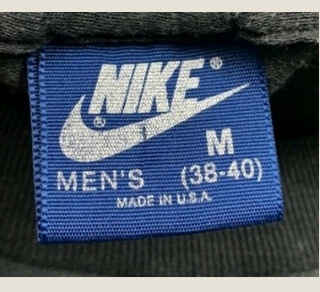 Vintage Nike blue tag, white Nike branding woven on a blue label